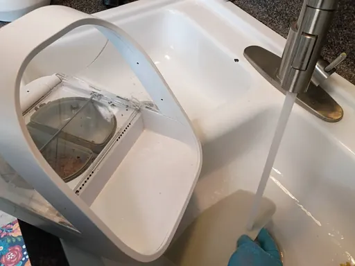 Small appliance being rinsed at a sink