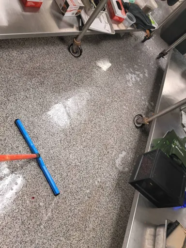 Commercial kitchen floor during cleaning