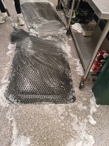 Commercial kitchen floor being scrubbed